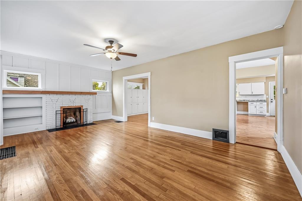 124 Wengler Avenue Sharon, PA 16146 - Photo 8 of 25 an empty room with wooden floor fireplace and a window