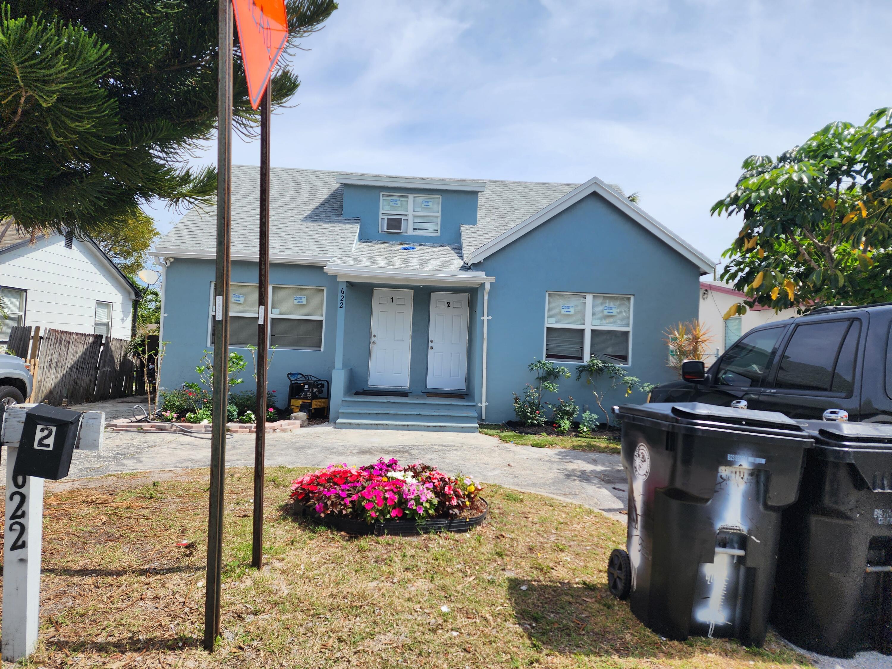 a view of a patio with table and chairs potted plants