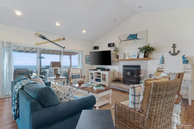 a living room with furniture a flat screen tv and a fireplace