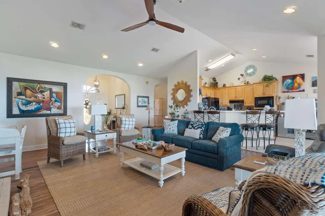 a kitchen with stainless steel appliances a table and chairs in it