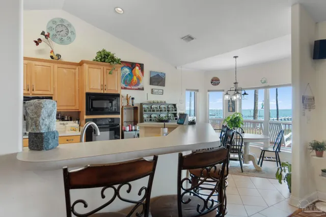 a view of a dining room with furniture and a chandelier