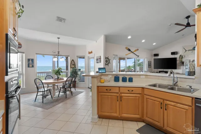 a bedroom with a bed and a flat tv screen on dresser