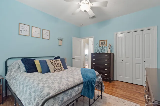 a bedroom with a bed and glass door