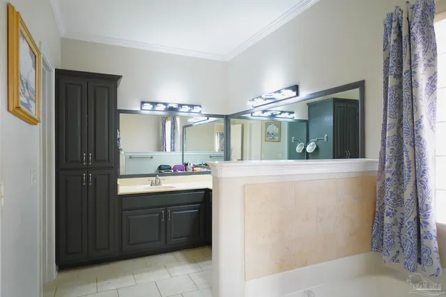 a patio with wooden floor a yard a table and chairs