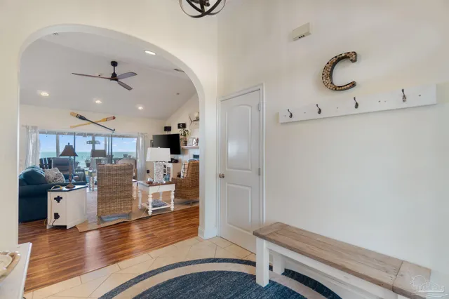 a living room with fireplace furniture and a large window