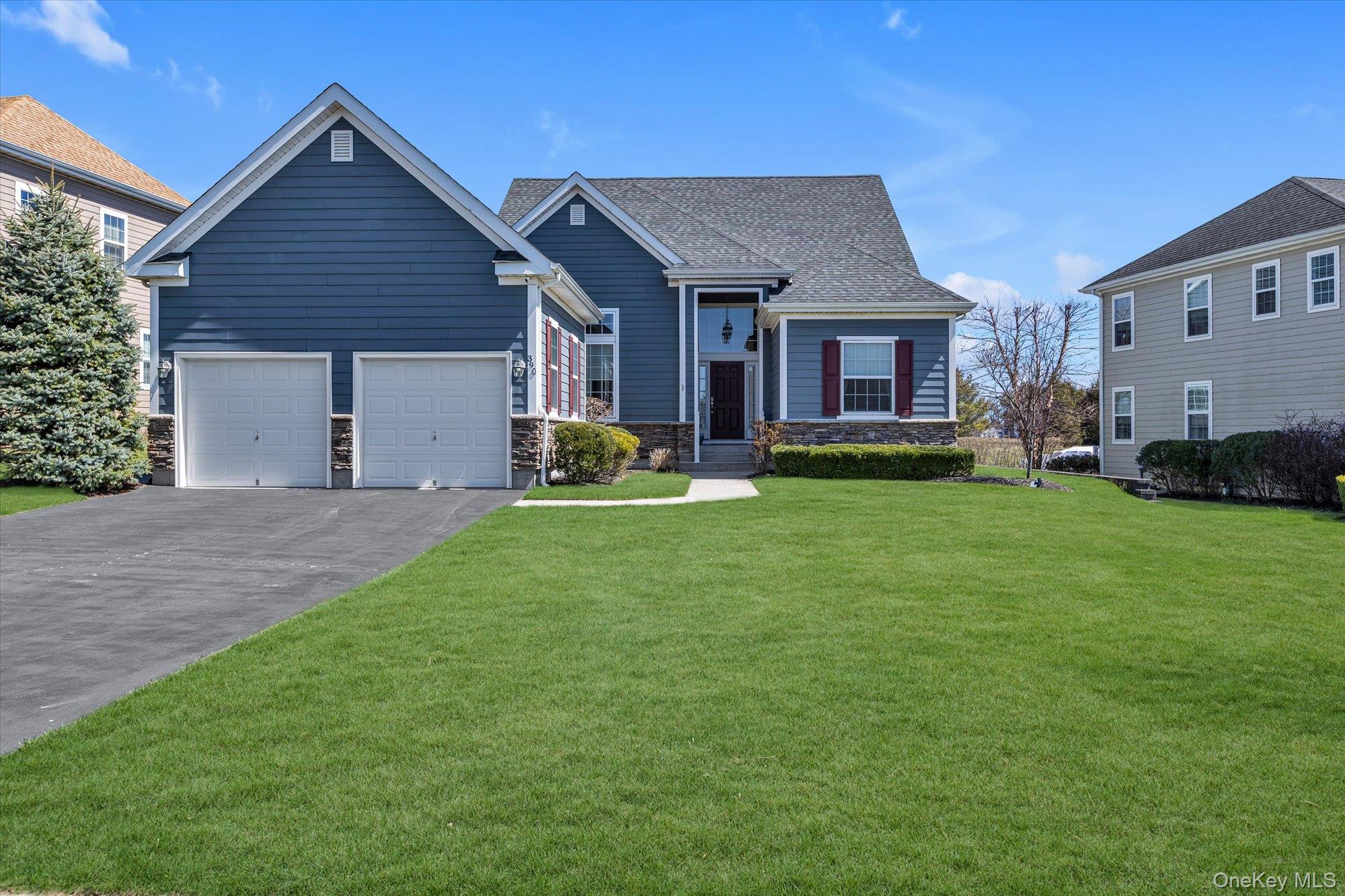 a front view of a house with a yard and trees
