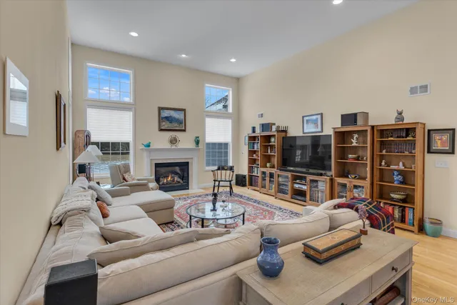 a living room with furniture a flat screen tv and a fireplace