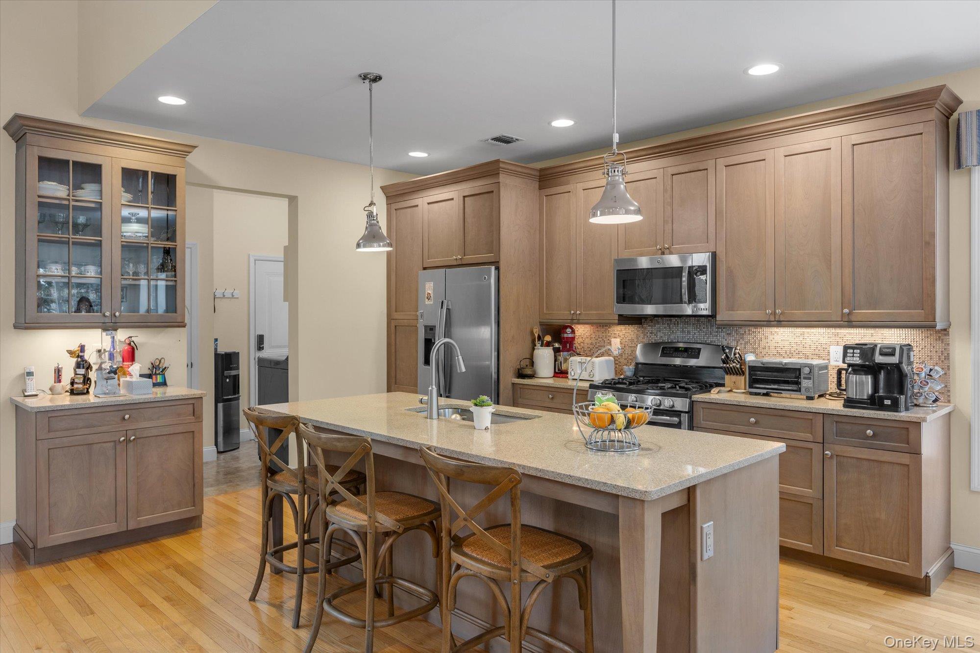 390 Stonecrop Road Riverhead, NY 11901 - Photo 11 of 24 a kitchen that has a lot of cabinets a sink and appliances in it