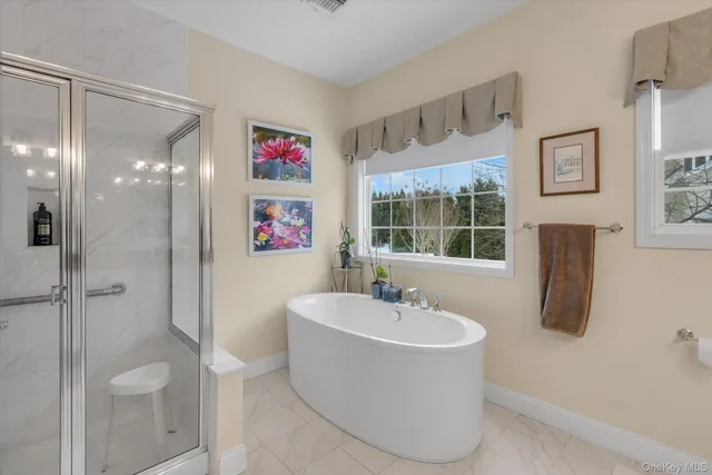 a spacious bathroom with a sink a toilet and a large mirror