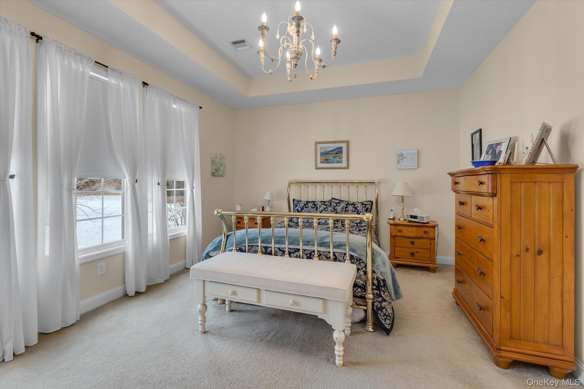 390 Stonecrop Road Riverhead, NY 11901 - Photo 13 of 24 a spacious bedroom with a bed and a table