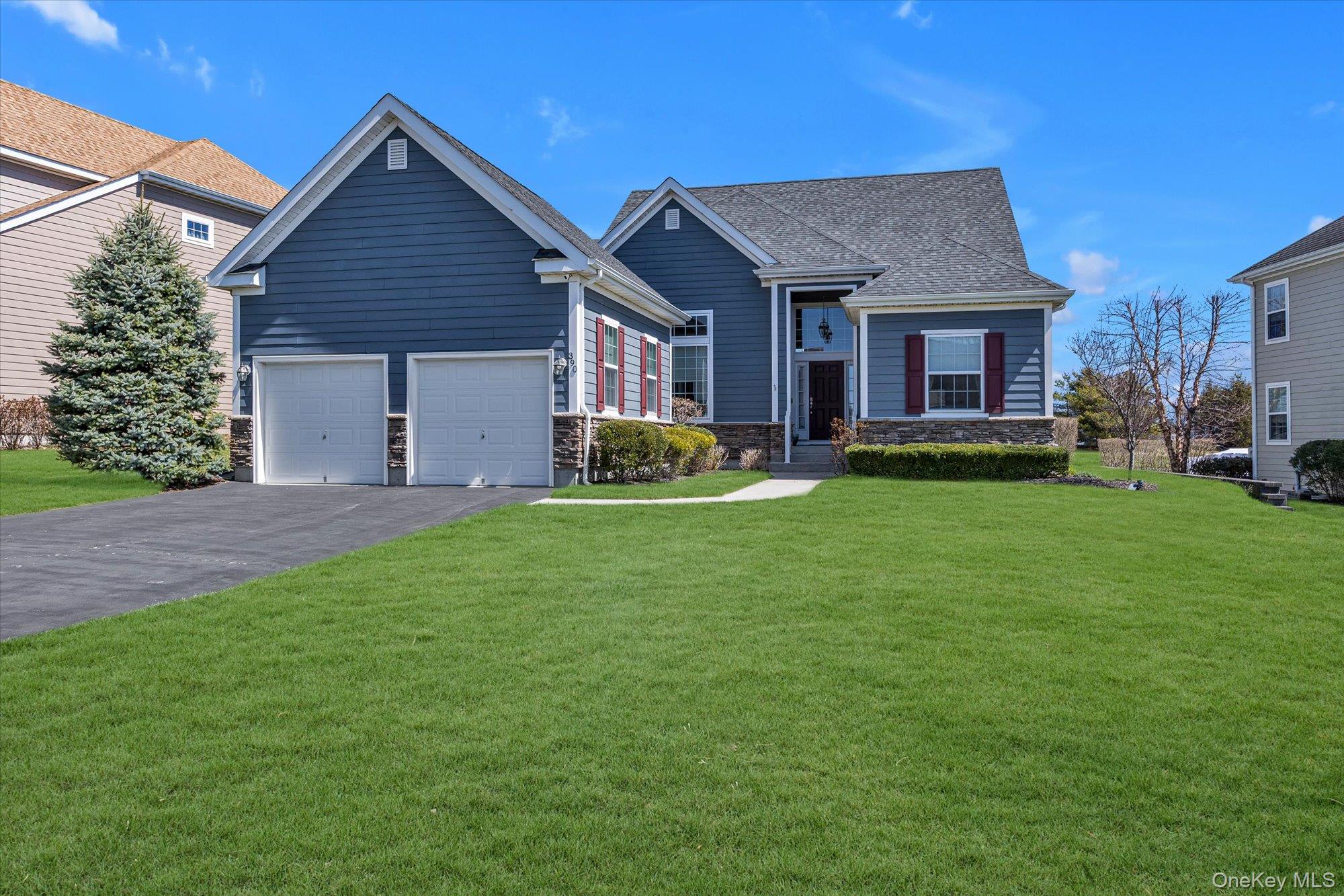 390 Stonecrop Road Riverhead, NY 11901 - Photo 2 of 24 a front view of a house with a garden and trees