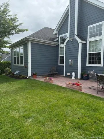 a view of a house with backyard and sitting area
