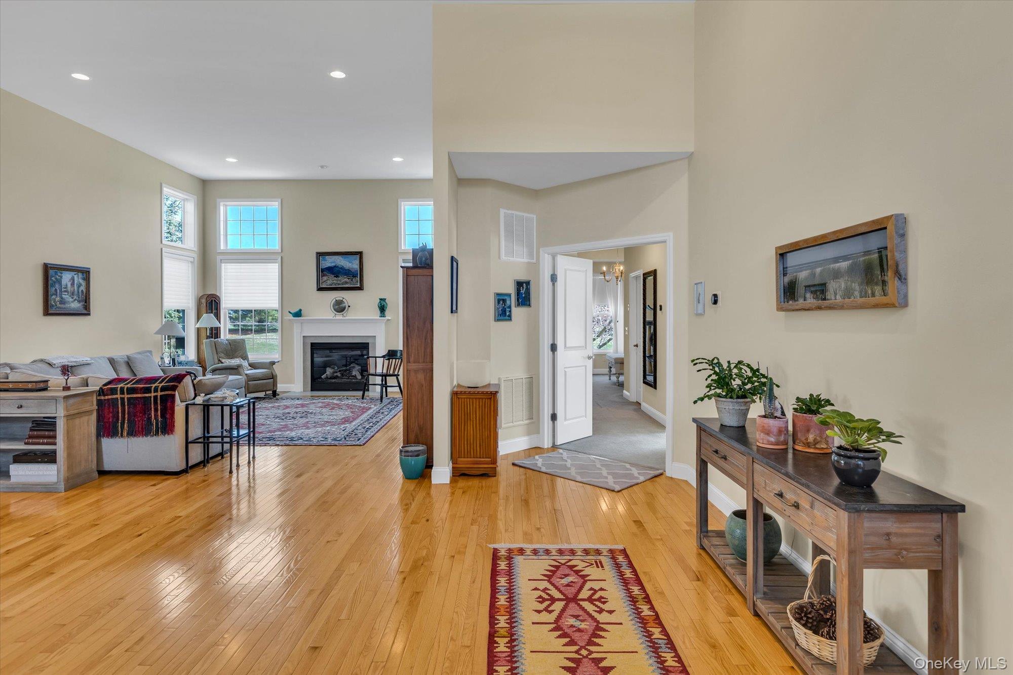 390 Stonecrop Road Riverhead, NY 11901 - Photo 4 of 24 a living room with fireplace furniture and a wooden floor