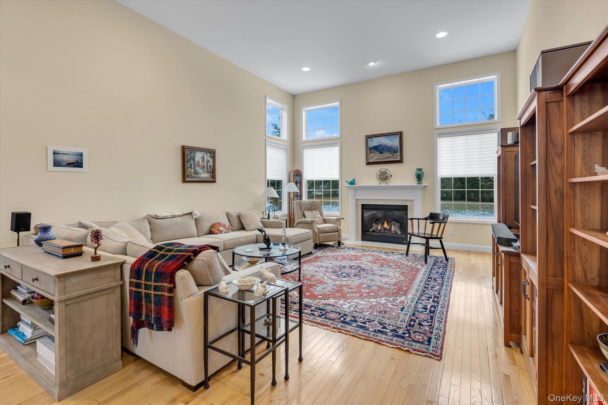 390 Stonecrop Road Riverhead, NY 11901 - Photo 8 of 24 a living room with furniture a flat screen tv and a fireplace