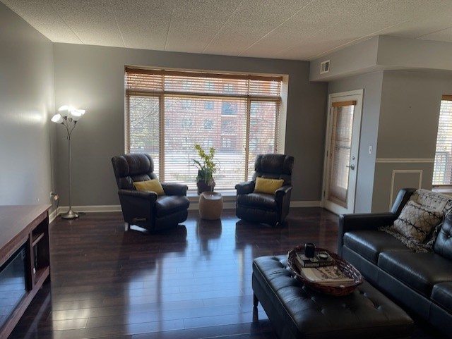 875 East 22nd Street, Unit 204 Lombard, IL 60148 - Photo 18 of 47 a living room with furniture and wooden floor