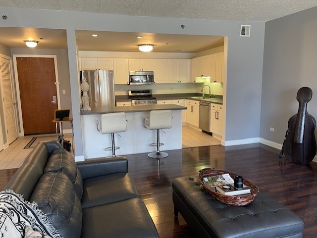 875 East 22nd Street, Unit 204 Lombard, IL 60148 - Photo 19 of 47 a living room with stainless steel appliances kitchen island granite countertop furniture and a view of kitchen