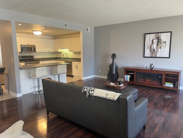 875 East 22nd Street, Unit 204 Lombard, IL 60148 - Photo 21 of 47 a living room with furniture and a fireplace
