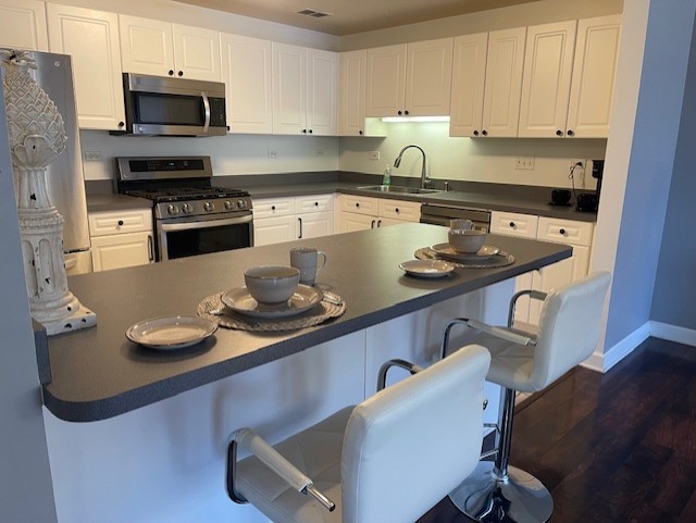 875 East 22nd Street, Unit 204 Lombard, IL 60148 - Photo 26 of 47 a kitchen with stainless steel appliances granite countertop a sink a stove and white cabinets
