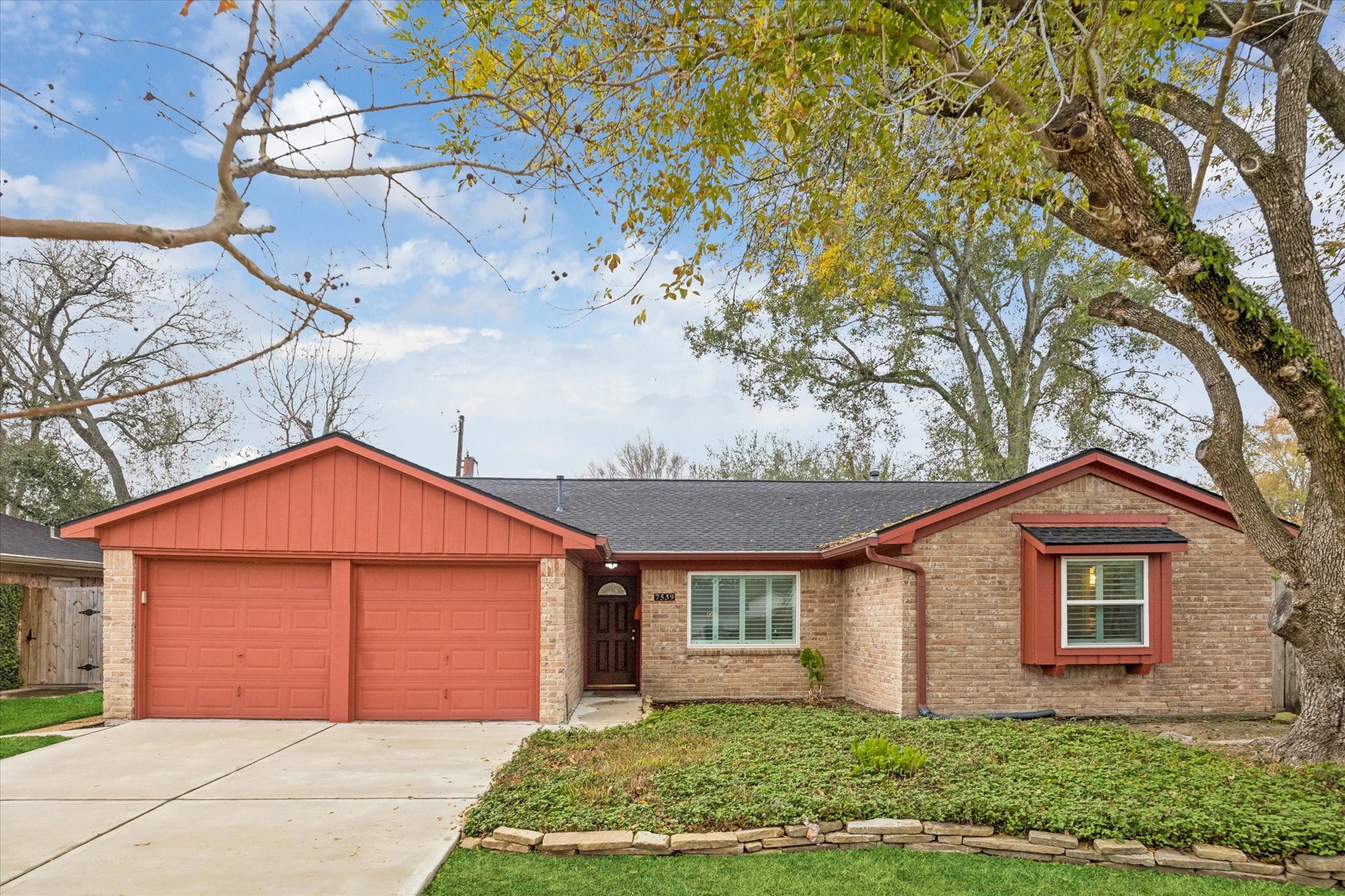 7539 Jason Street Houston, TX 77074 - Photo 15 of 16 a front view of a house with a yard and garage