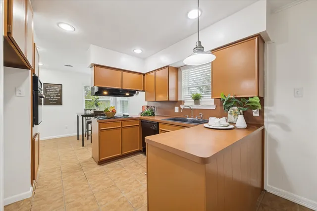 a kitchen with a sink refrigerator and cabinets