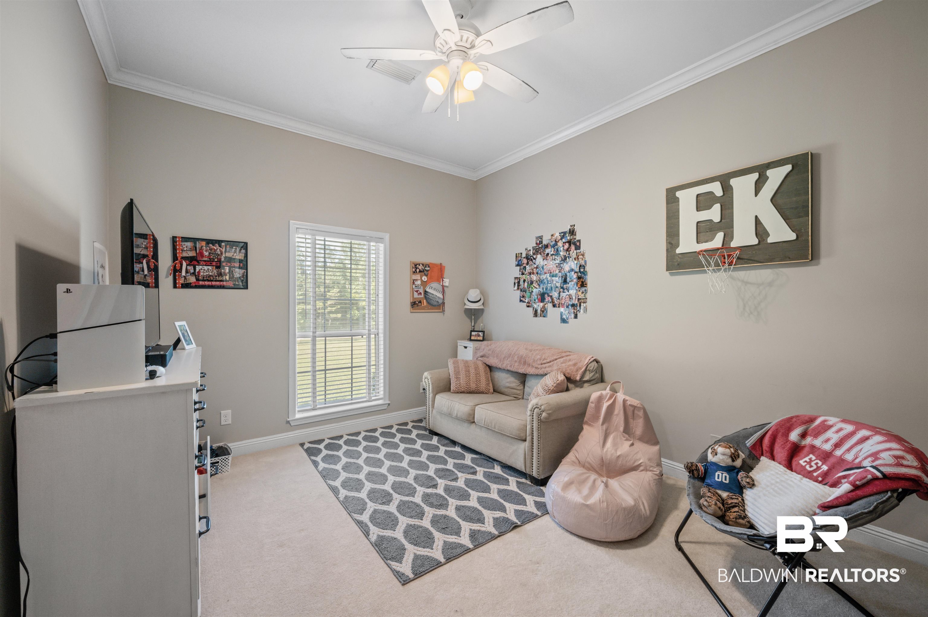 141 Blue Ridge Drive Monroeville, AL 36460 - Photo 18 of 40 Carpeted living room featuring a ceiling fan and crown molding