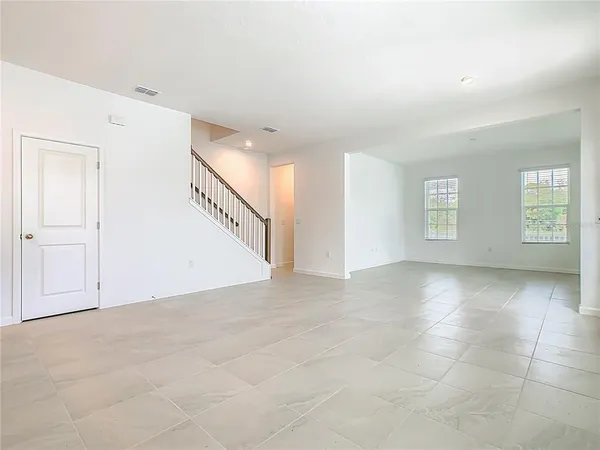 a view of an empty room with windows