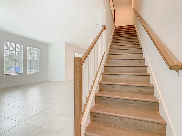 a view of staircase with white walls and windows