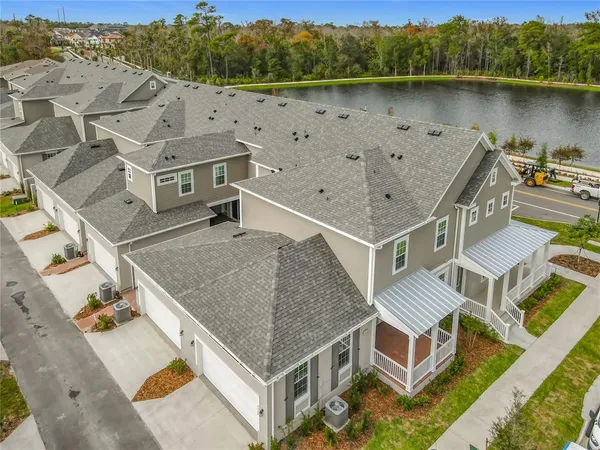 an aerial view of a house with a lake view
