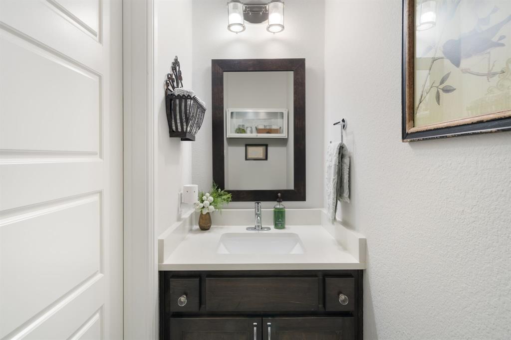 16509 Prairie Oak Road Frisco, TX 75033 - Photo 20 of 39 a bathroom with a sink and a mirror