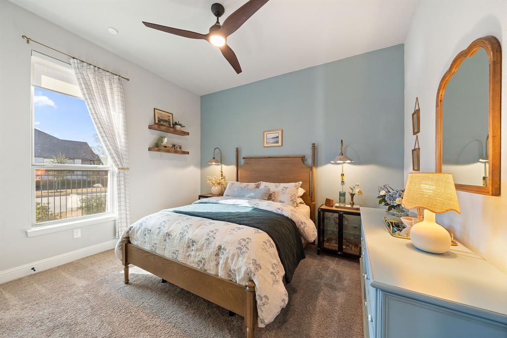 16509 Prairie Oak Road Frisco, TX 75033 - Photo 22 of 39 a bedroom with a bed and dresser with mirror