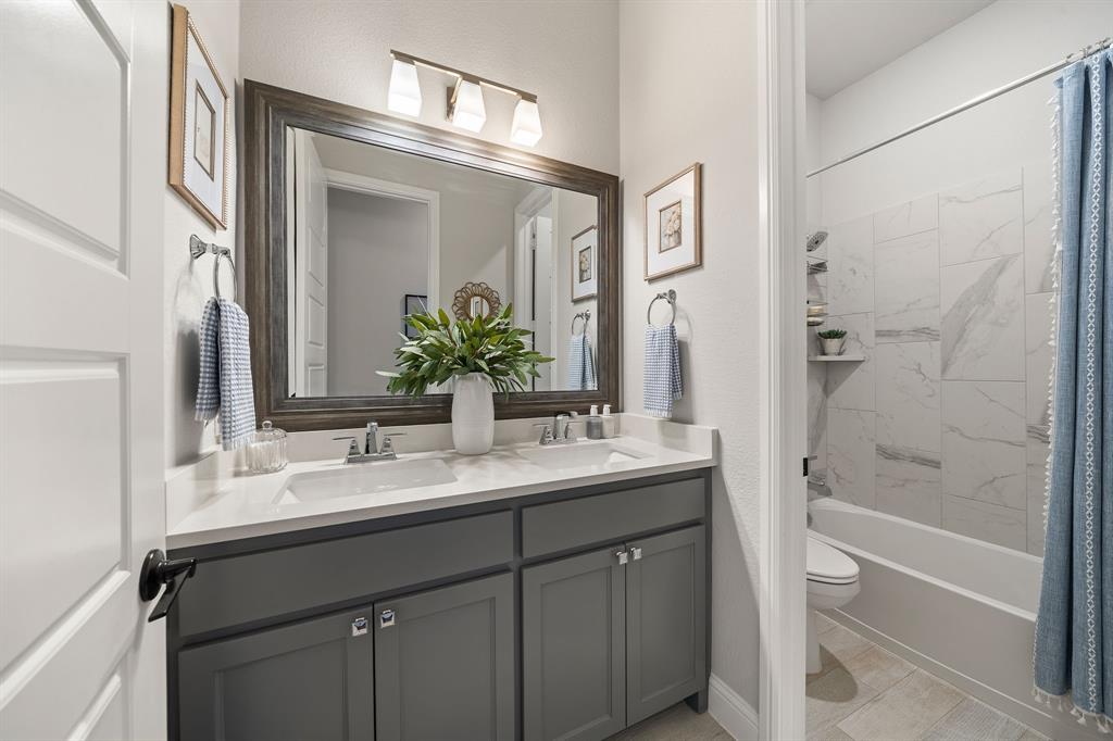 16509 Prairie Oak Road Frisco, TX 75033 - Photo 24 of 39 a bathroom with a double vanity sink mirror double and shower