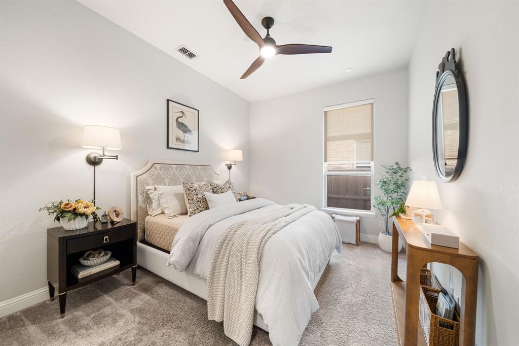 16509 Prairie Oak Road Frisco, TX 75033 - Photo 25 of 39 a bedroom with bed and a chandelier
