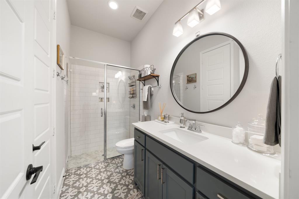 16509 Prairie Oak Road Frisco, TX 75033 - Photo 27 of 39 a bathroom with a sink a toilet and a mirror