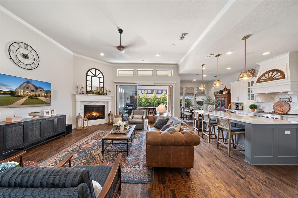 16509 Prairie Oak Road Frisco, TX 75033 - Photo 5 of 39 a living room with furniture and a fireplace
