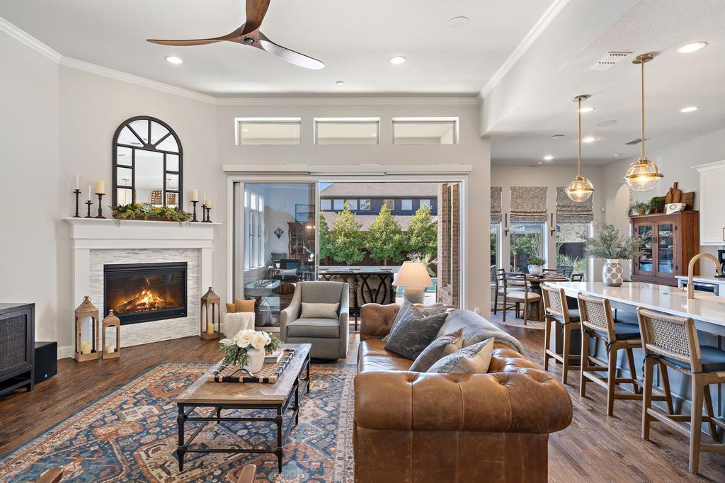 16509 Prairie Oak Road Frisco, TX 75033 - Photo 7 of 39 a living room with furniture and a fireplace