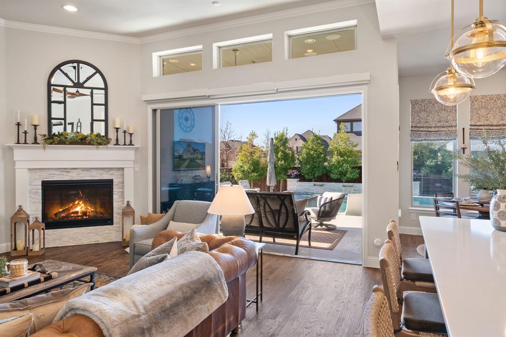 16509 Prairie Oak Road Frisco, TX 75033 - Photo 8 of 39 a living room with furniture and a fireplace