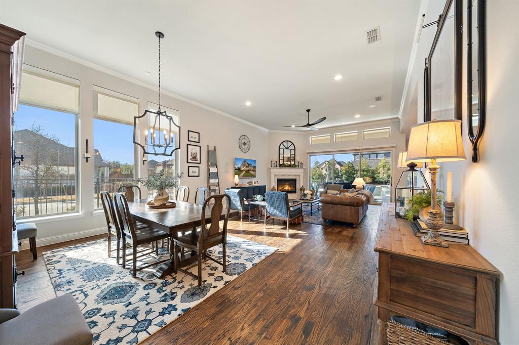 16509 Prairie Oak Road Frisco, TX 75033 - Photo 10 of 39 a view of a dining room and livingroom with furniture wooden floor a chandelier