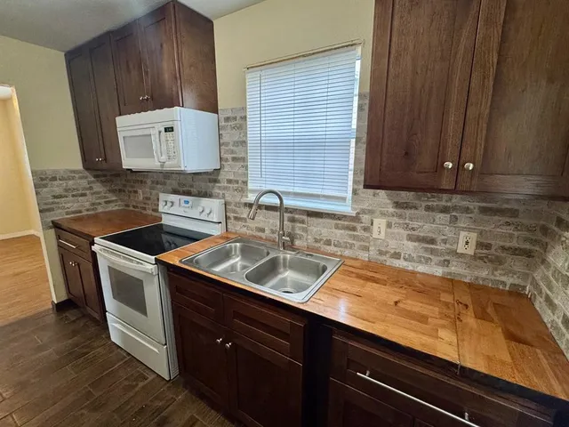 a kitchen with a sink stove and cabinets