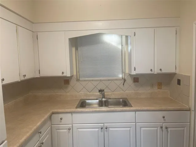a kitchen with a sink and cabinets