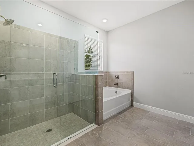 a bathroom with a bathtub and shower