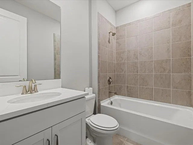 a bathroom with a sink a toilet and bathtub