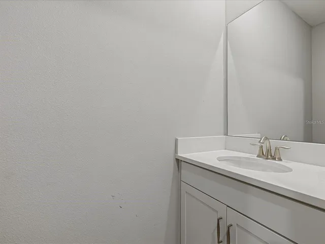 a bathroom with a sink and vanity