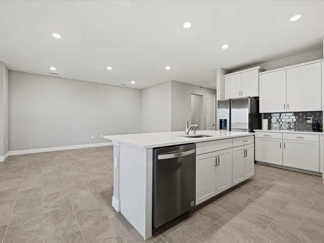 a kitchen with granite countertop white cabinets and white appliances
