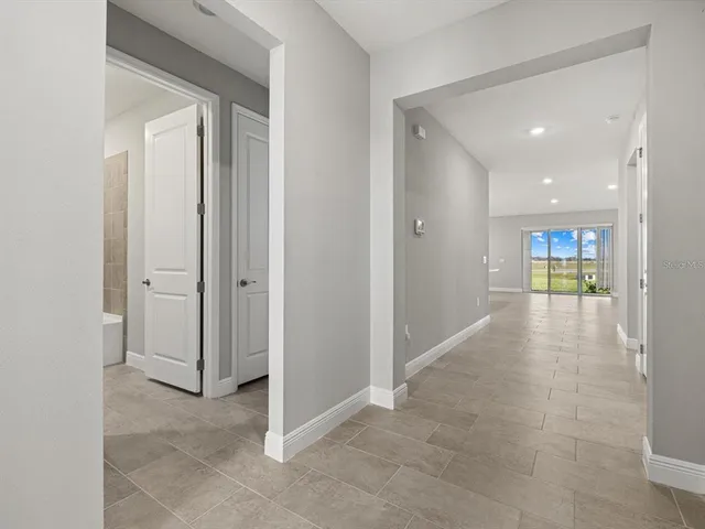 a view of a hallway with wooden shelves