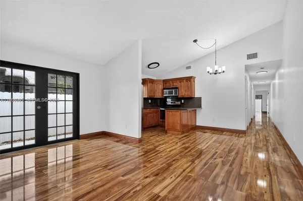 a view of a kitchen with wooden floor