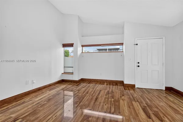 a view of a room with wooden floor