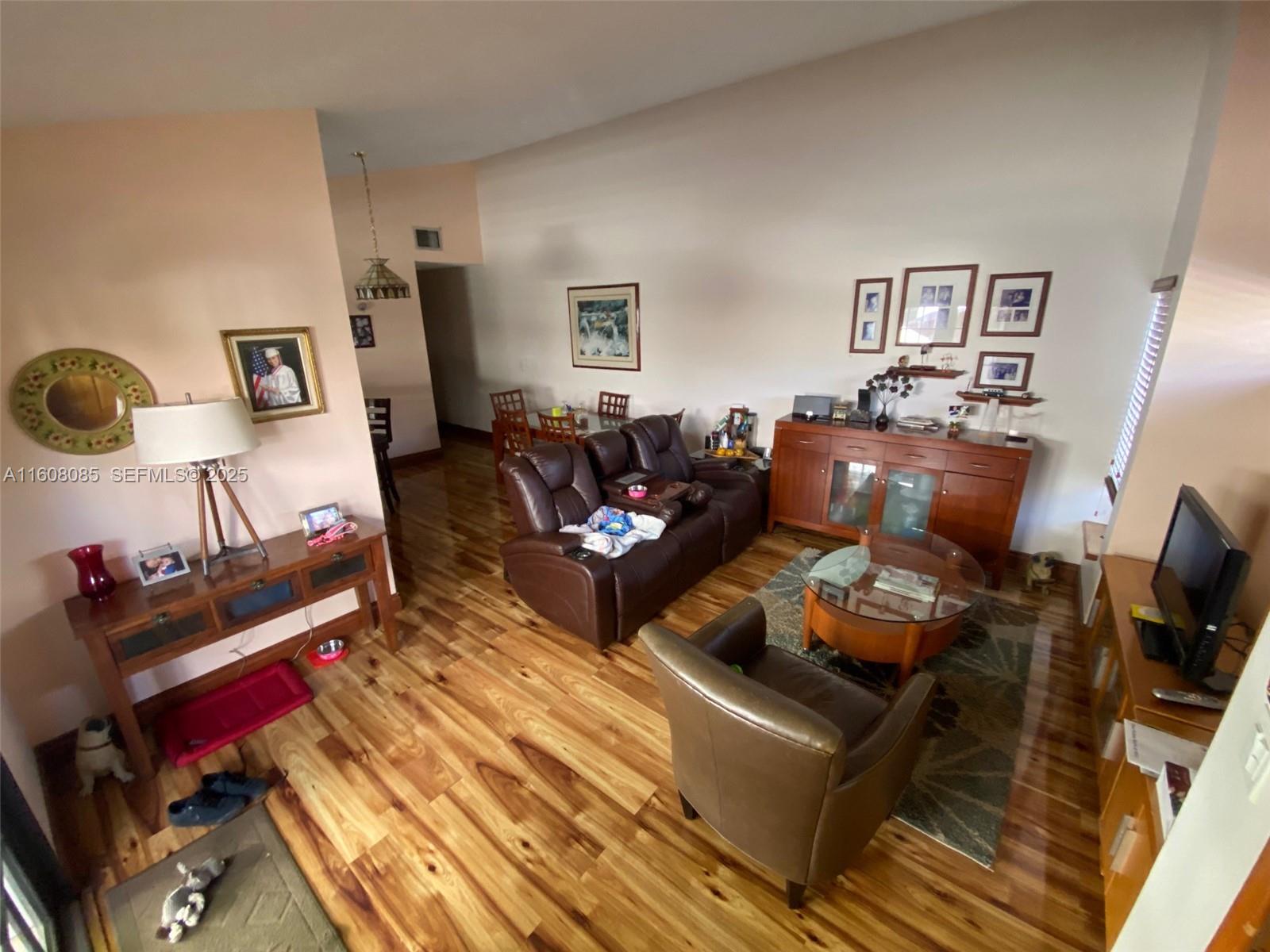 1632 Southwest 19th Terrace Miami, FL 33145 - Photo 2 of 16 a living room with furniture and a flat screen tv