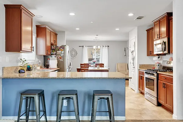 a kitchen with stainless steel appliances granite countertop lots of counter top space and cabinets
