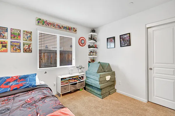 a bedroom with furniture and a window