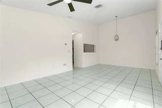 an empty room with ceiling fan